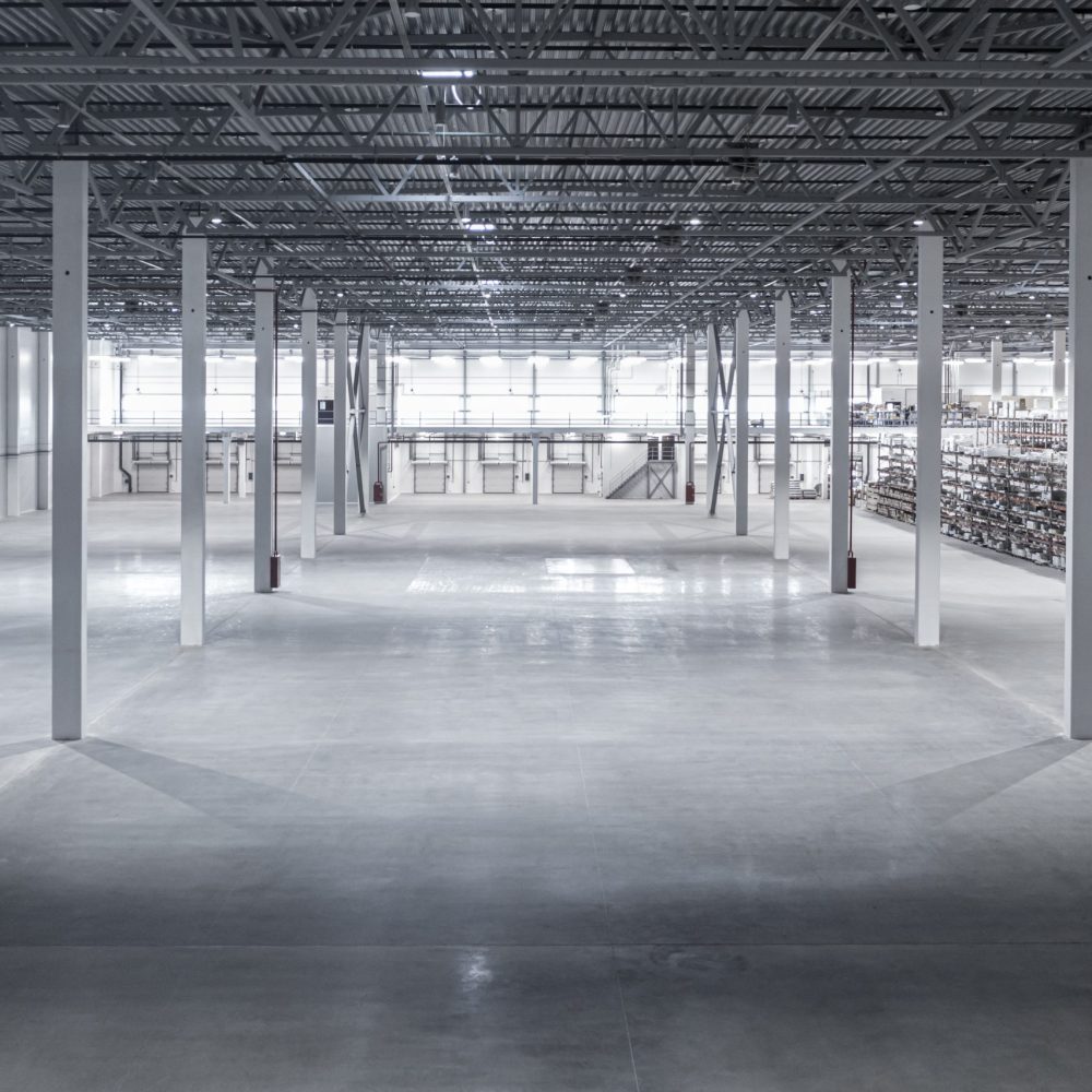 Factory or warehouse or industrial building. Protection with roller door or roller shutter. Modern interior design with concrete floor, steel wall and empty space for industry background.